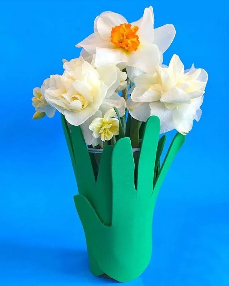 To match up with the coffee filter flowers, you can craft this handprint vase for Mother&rsquo;s Day! This budget and kid-friendly craft will make your Mom smile brighter than a bouquet of flowers.