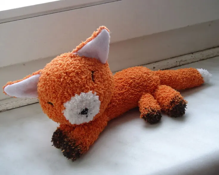 This sleeping fox stuffed animal is made with one white and one orange fluffy sock. The details added on using a fabric marker and felt, as well as bits of embroidery for the facial features. Make this sleeping companion for yourself and you'll sure to have a wonderful night of sleep.