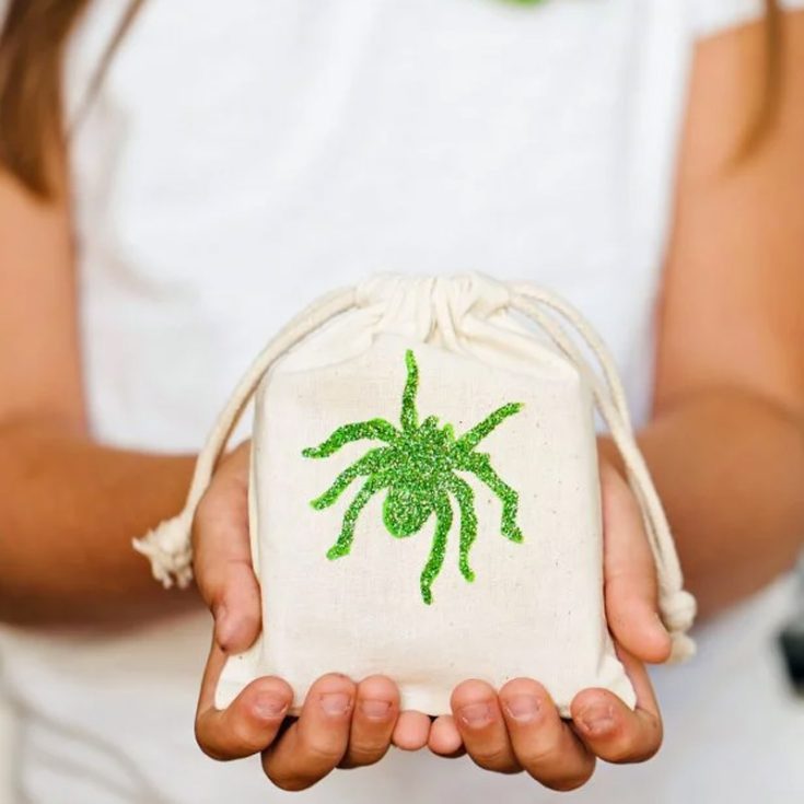 Turn plain fabric bags into delightful Halloween party favors with paint and glitter! Choose from one of the four designs, or create one to add a personal, crafty touch that kids will love. It&rsquo;s a fun project that is perfect for getting into the Halloween spirit!