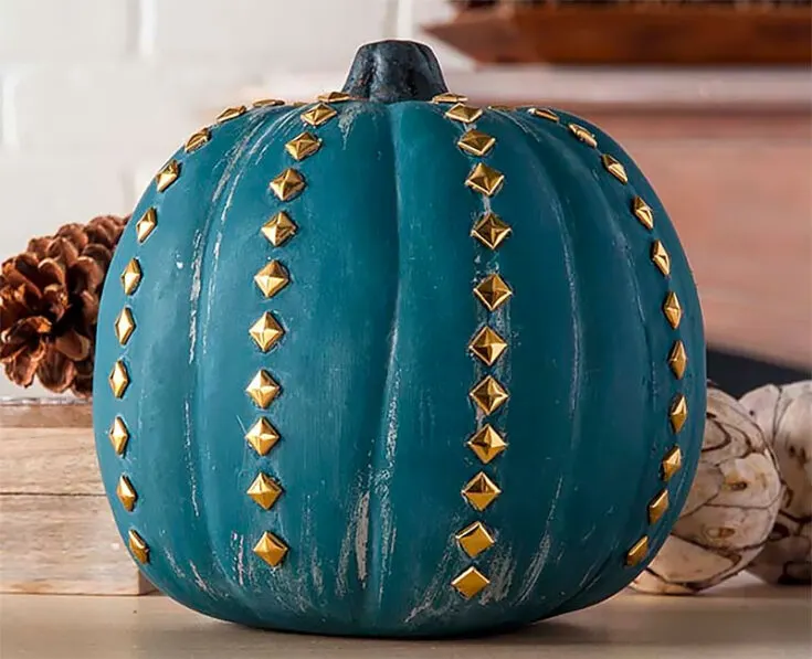 Are you tired of bright colors and orange and blacks? Welcome this lovely gold-studded pumpkin with a chalk finish. It'll definitely be a statement piece in your house.