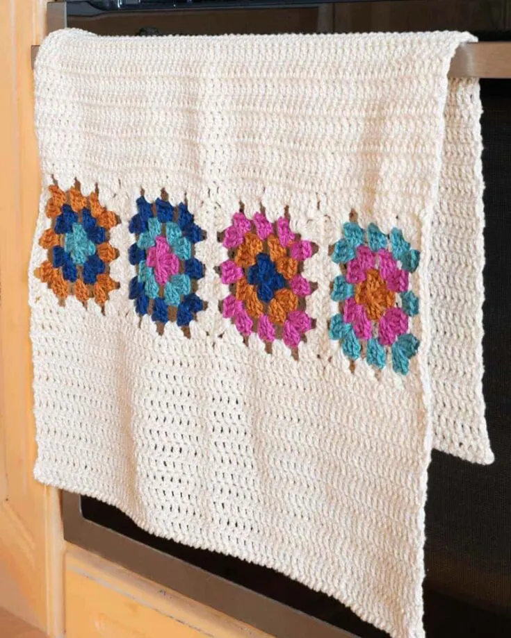 This quick basic granny square project is for beginners. It&rsquo;s made up of a combination of four squares and finished off with crab stitches. Be creative and pick any five colors that would go well with your kitchen. It certainly adds character to any space.