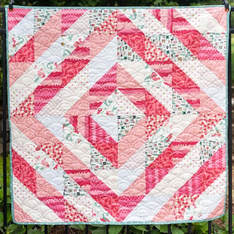 This half-square triangle baby quilt by Polka Dot Chair is so breathtaking! Though the pattern is simple, the playful layouts and vibrant colors bring so much life to any nursery decor! The finished quilt size is 48&rdquo; x 48&rdquo;.