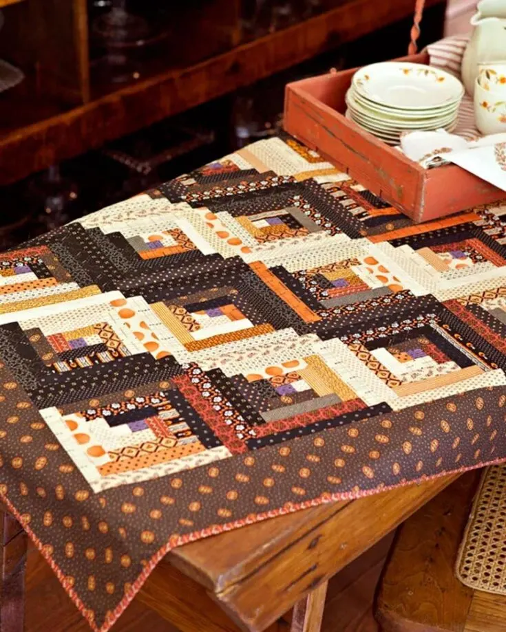 Prepare to add a touch of fall to your favorite log cabin quilt patterns. This harvest table runner quilt can be doubled as a regular quilt to be your companion during those cold, chilly nights. The prints used are in fall hues and use the straight furrows setting. The finished size is 35 x 48 &frac12;&rdquo;.