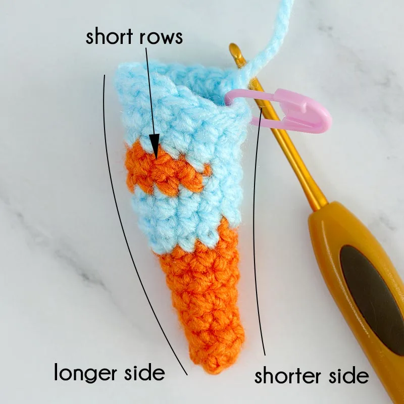 To create a naturally curled tail, crochet short rows to form a longer outer side and a shorter inner side, making the tail bend smoothly.