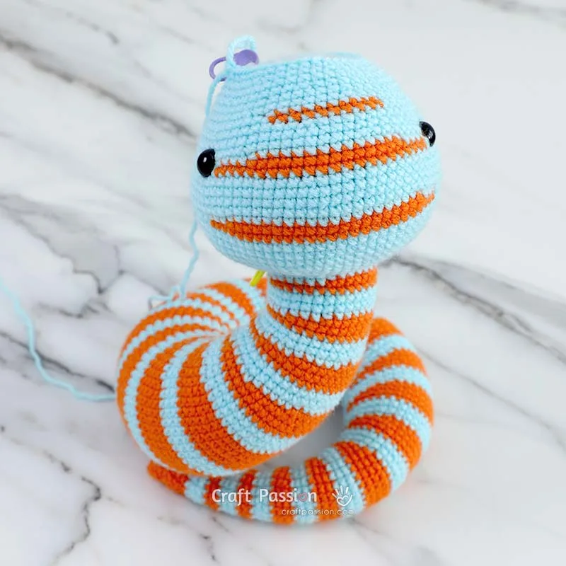 Continue crocheting the head and attach the safety eyes as instructed in the pattern.