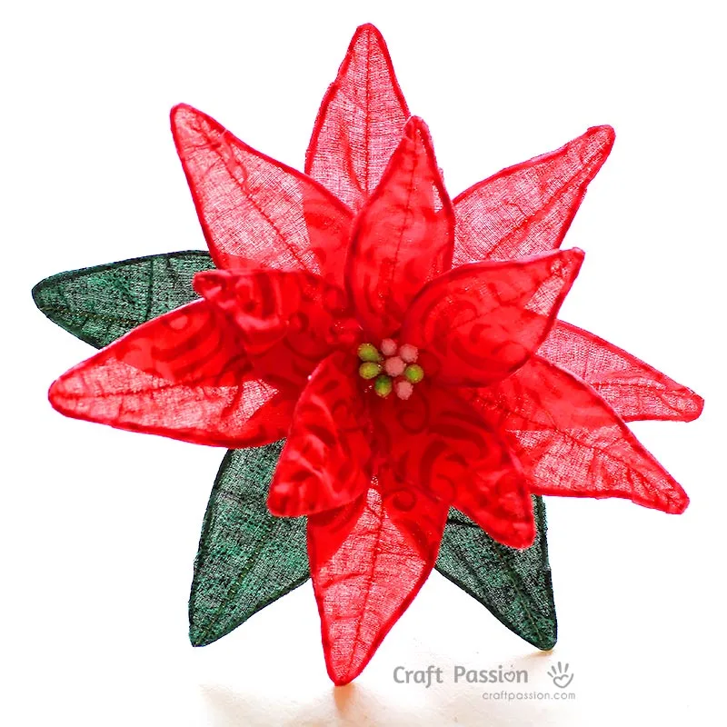 Learn how to make a fabric flower with this simple poinsettia tutorial. Use fabric and wire to create festive Christmas decorations or DIY bouquets.