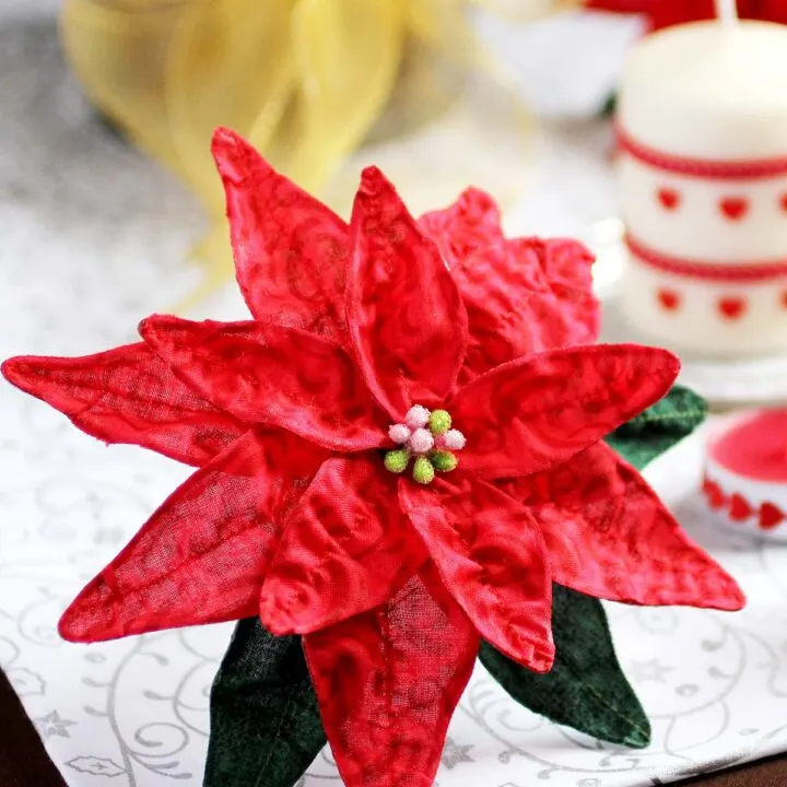 Learn how to make a fabric flower with this simple poinsettia tutorial. Use fabric and wire to create festive Christmas decorations or DIY bouquets.