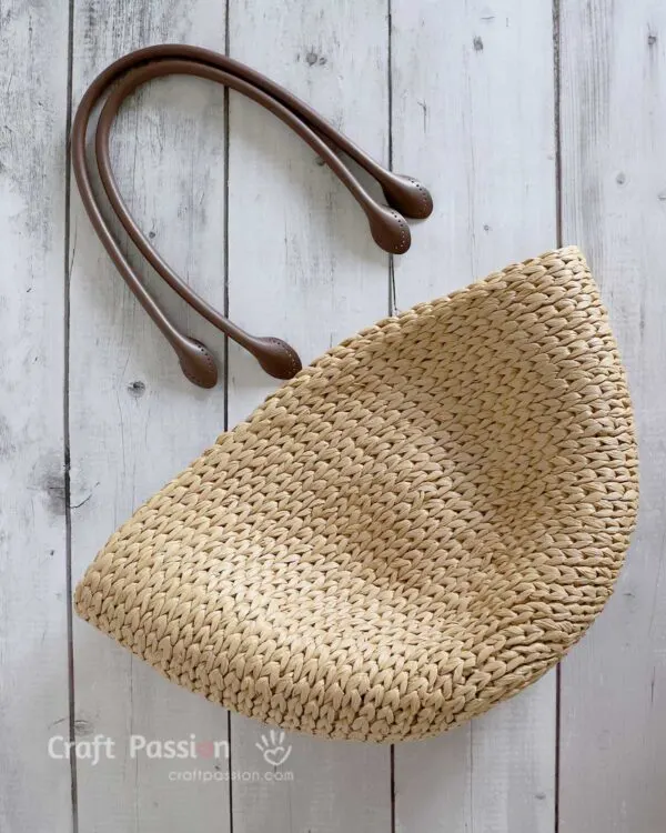 You just need raffia yarns, bag handlers, and basic crochet tools to complete an elegant straw bag with this free crochet pattern.