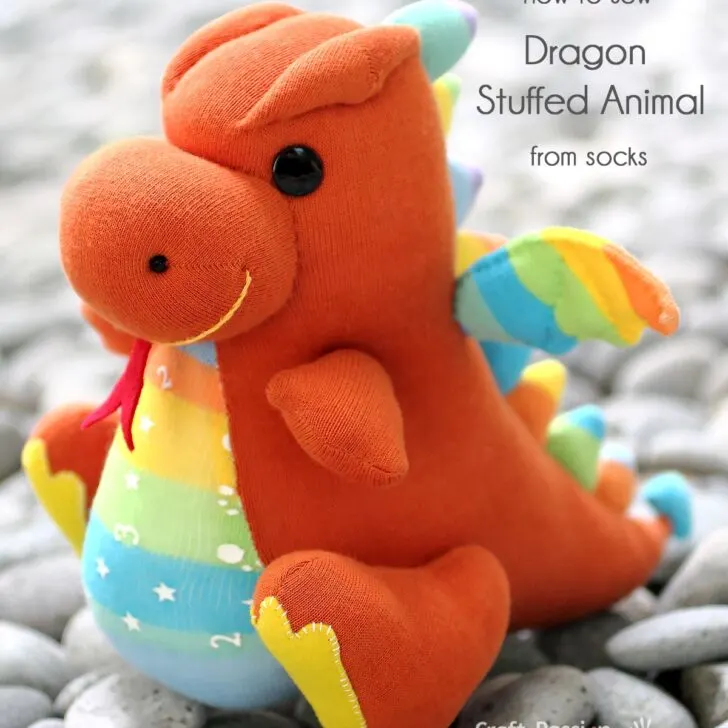 Sew a cute dragon stuffed animal, Drake, with 2 pairs of socks! Features spiky back, bat wings, and big feet. Free pattern and tutorial included!
