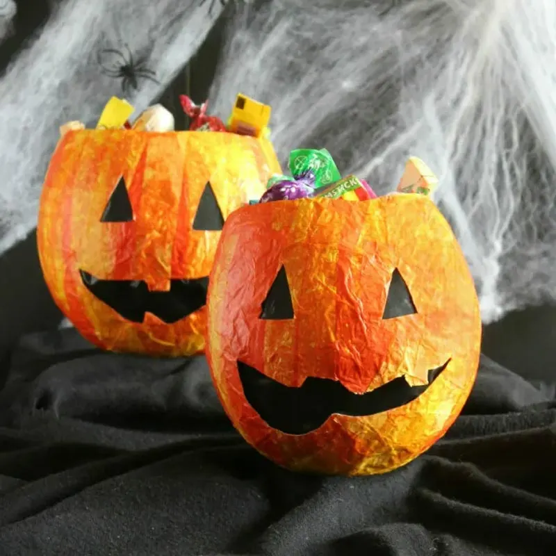 These papier-mache candy bags are a great alternative to real pumpkins; they are less messy and way less work! They're easy for kids to help create, making them a fun and fuss-free Halloween craft, and they add a playful touch to your festivities.