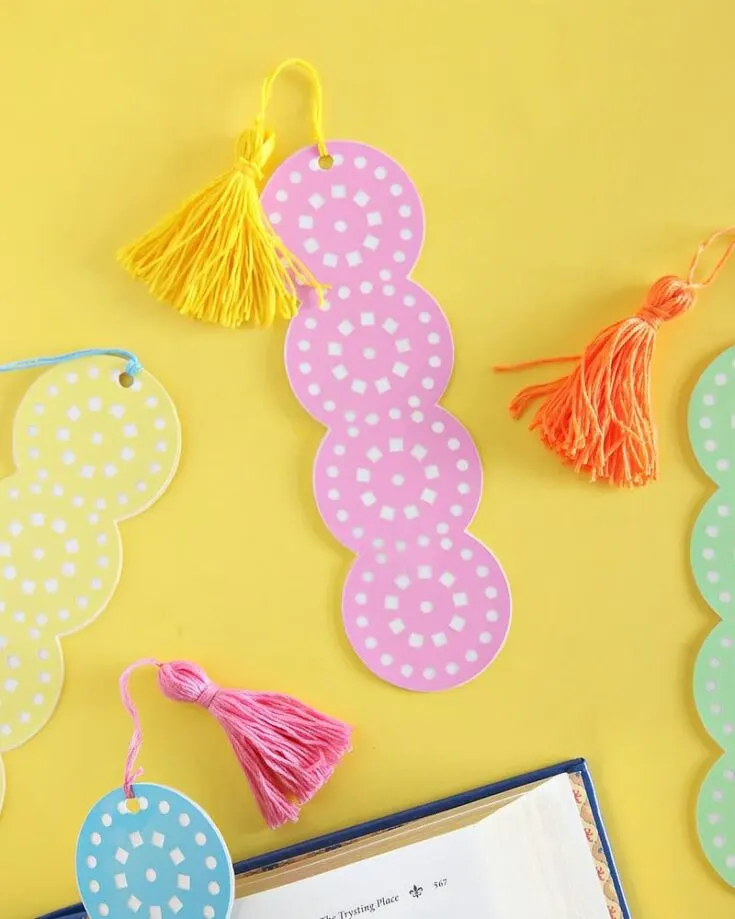 Get ready for summer reading with these lace-cut bookmarks! It is a fun craft that combines colorful cardstock, lace patterns, and tassels for a fun and unique look. Keep track of your pages with style!