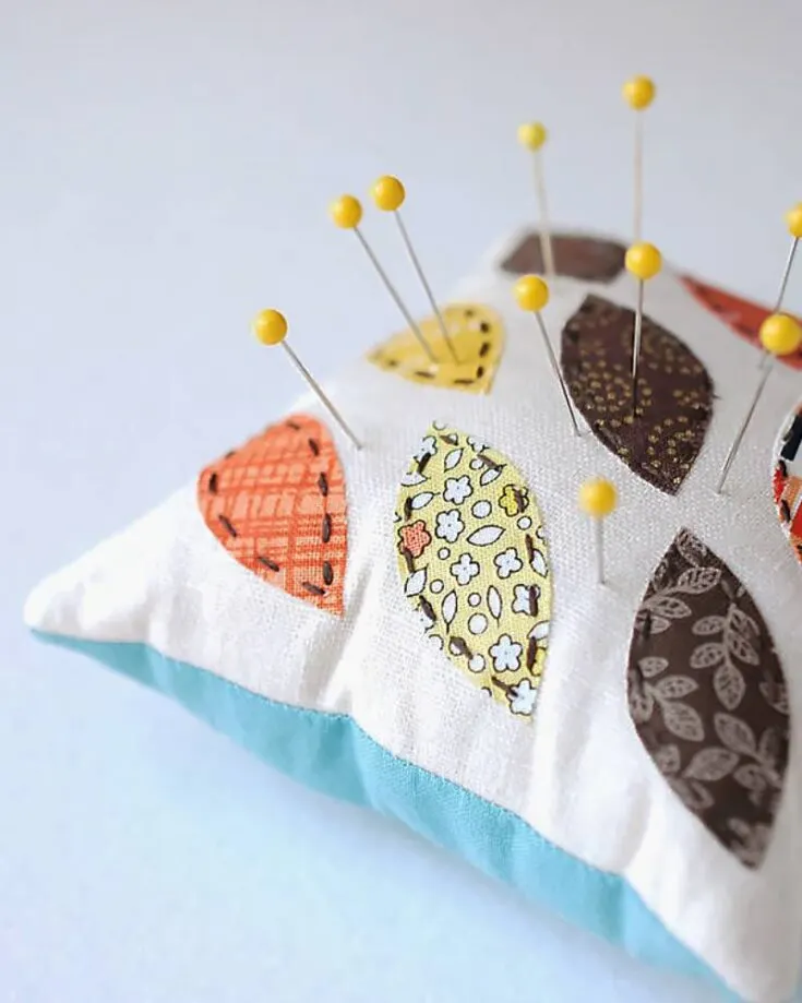 Learn how to make this leaf pincushion pattern that uses appliques to create the beautiful leaf pattern you see here. It&rsquo;s simple and yet another great way to use up scrap fabric.