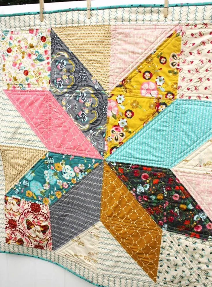 This baby quilt pattern features a beautiful kaleidoscopic lone star motif against a pastel background. You'll require 16 pieces of precut 10" x 10" squares to complete this 39" x 39" baby quilt.