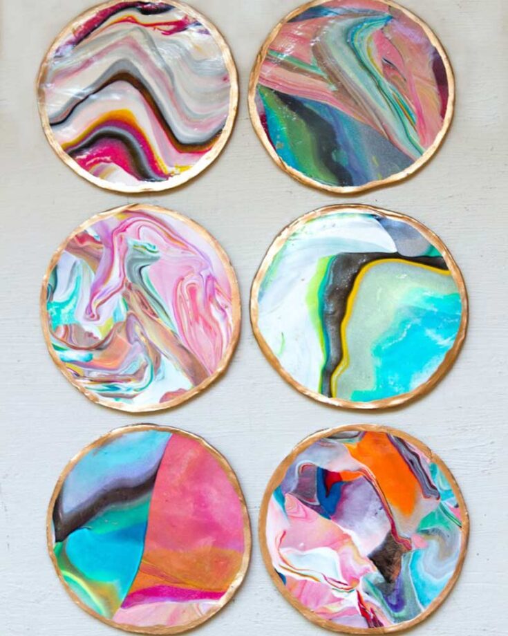 Design your marble coasters by blending different colors of polymer clay to create fun and vibrant patterns. Finish with a gold accent around the edges for a touch of elegance using gold paint.