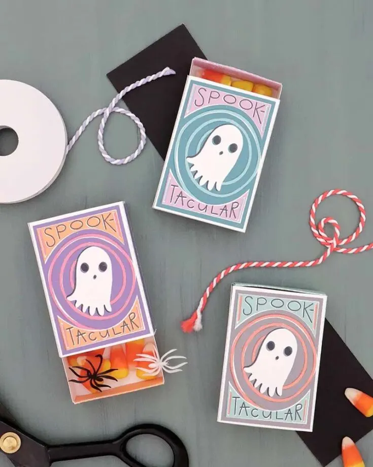 Just add a fun design to a basic matchbox to make Halloween paper treat boxes. Its size is perfect for small candies or little crafts. It's easy to do with the free printables in the guide, making your own cute and festive boxes in no time!