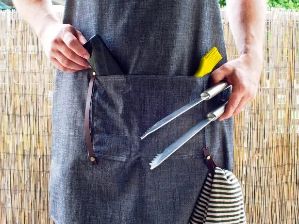 Want to make your spouse or dad a handy bespoke apron? Well then, look no further! Not only does it have a phone pocket beside its storage pocket, but it also has a leather loop to hang any cloth when it gets messy.