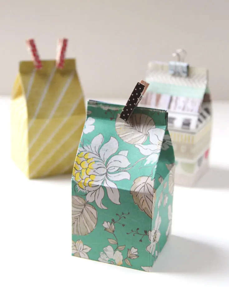 Craft adorable DIY mini milk carton gift boxes that are perfect for party treats, wedding favors, or wrapping chocolates! These cartons feature a special design, and you can use colorful scrapbook paper to add a fun touch to any occasion!