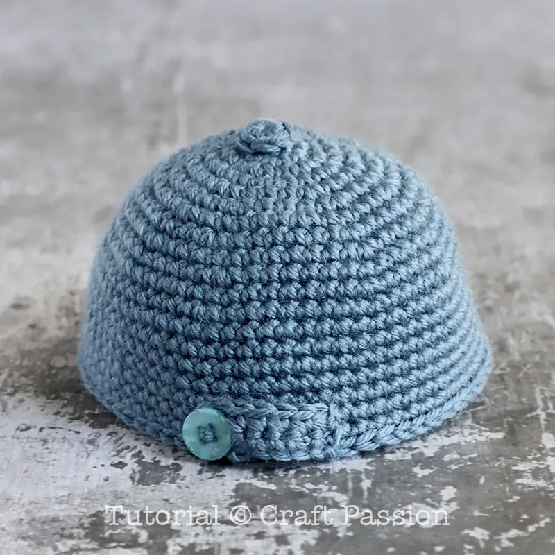 mini crochet cap with a button at the back
