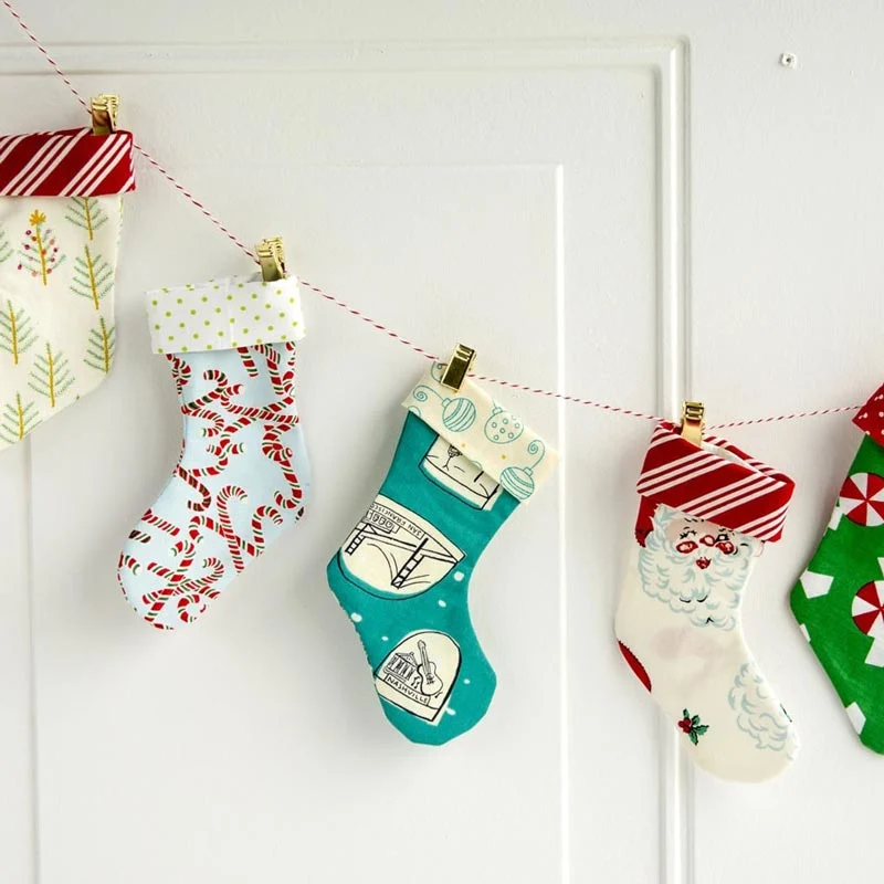 Deck the halls with the charm of crafting this cute design by Polkadot Chair. Check out their adorable rendition of Christmas decor with a mini Christmas stocking garland that adds festive flair in a snap! String together these adorable stockings for a cute and cheerful holiday vibe.
