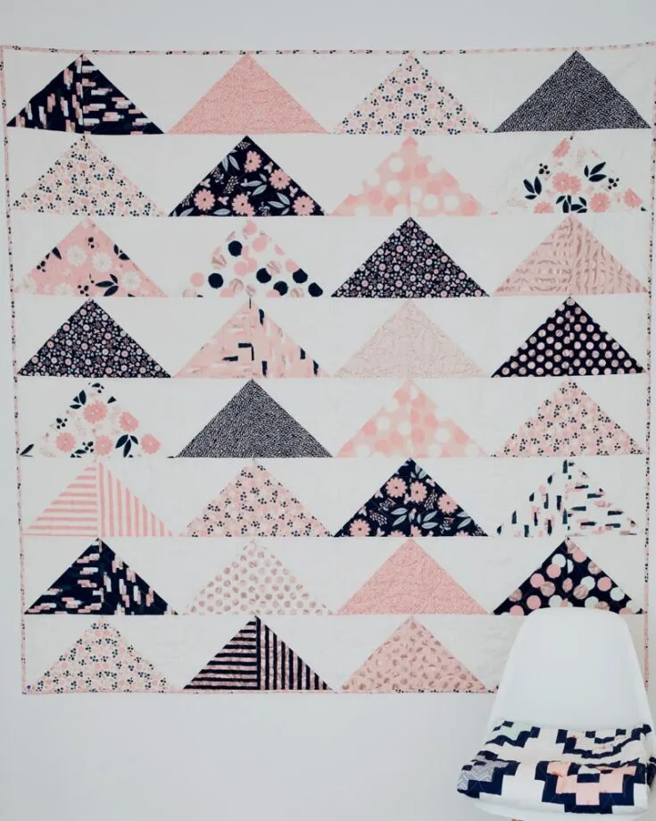 For those who adore the minimalism aesthetic, you must try quilting this Minimal Triangles Quilt pattern! This design combines simplicity with elegance and features geometric half-square triangle blocks pieced together to form this lovely triangle pattern. It&rsquo;s a satisfying experience from start to finish, resulting in a huge quilt size of 80&rdquo; x 80&rdquo;.
