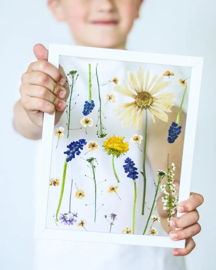 Similar to the pressed flower suncatchers, this one is just in a picture frame for Mom! All you need to prepare are some fresh blooms from your yard, sandwich them between paper, and let them flatten under heavy books.