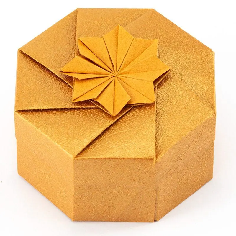 This beautiful gift box is the perfect tutorial for gifts that you plan to spoil your loved ones with. Try using some textured paper for a more grandiose feel. We recommend using gold dust origami paper!