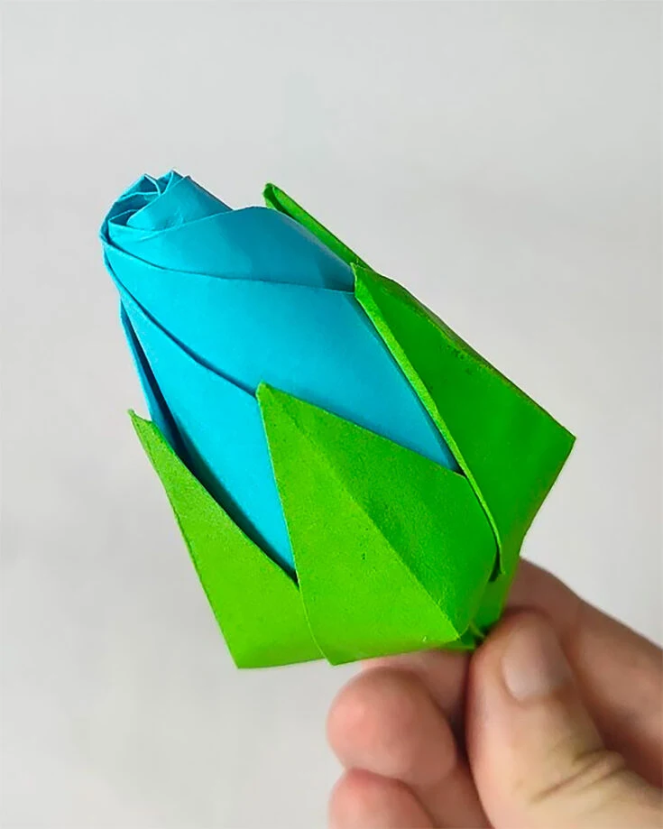 The bouquet of roses you've been folding wouldn't be complete without this origami rosebud.