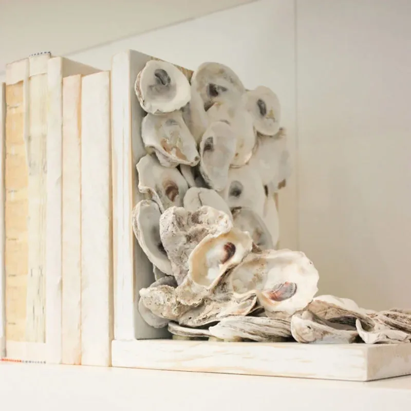 Give your bookshelf a splash of ocean charm by crafting these stylish oyster shell bookends. It brings a beachy vibe right to your home and makes a fun, functional addition to your decor! Not only do they look fabulous, but they also keep your favorite books perfectly in place.