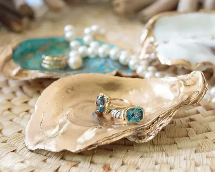This charming oyster shell craft is the perfect reason to enjoy a seafood dinner! Save your shells to create beautiful jewelry dishes that sparkle with a touch of liquid leaf and metallic nail polish. With their natural beauty enhanced, these oyster shell holders are both stunning and unique.