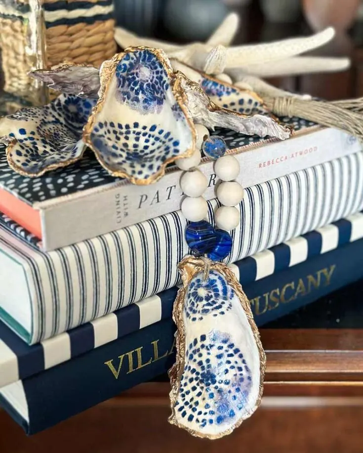Decoupage oyster shells with decorative napkins and put it together with a wood bead garland for a unique touch to your decor. You can hang it on a mantel or wall for a classic look or drape it over a bookshelf or coffee table for a subtle hint of natural beauty.