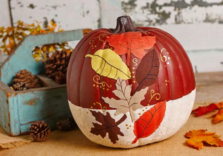 Paint some foliage in an autumn color palette, and you've got a painted pumpkin ready as your fall centerpiece! What's interesting is that this painted pumpkin idea uses crackle paint and Mod Podge for the leaves.