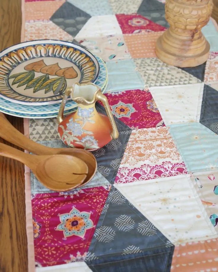Don't you love how beautiful this design is? This runner adds a boho vibe that is perfect for showing off your favorite print. It's a confident beginner and intermediate design that uses fat quarters to complete this quilt.&nbsp; Table runner size: 21" x 69"
