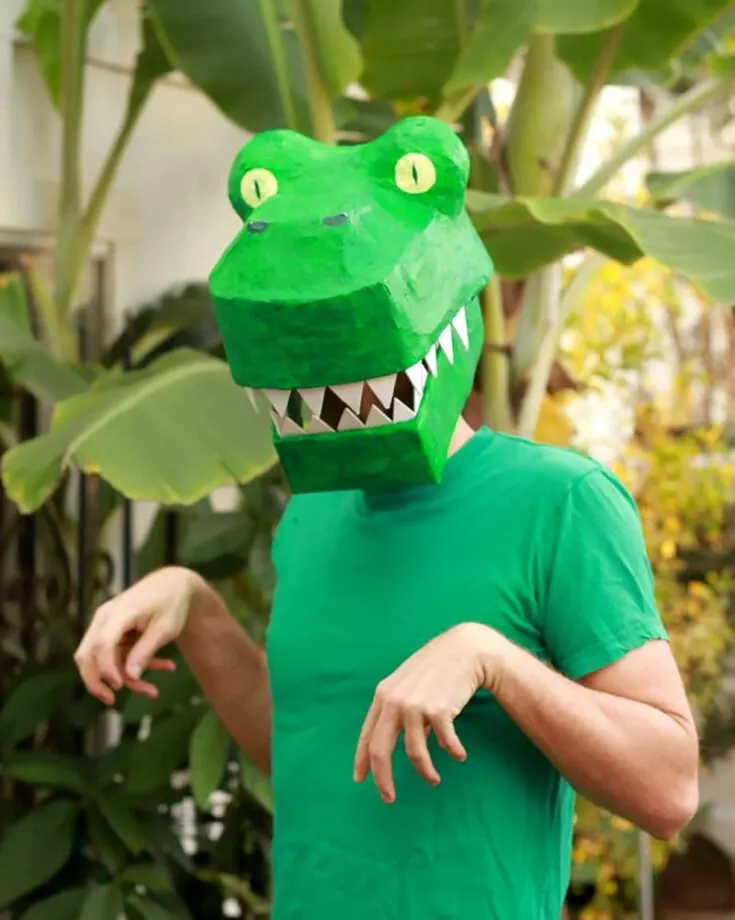 Make this stunning dinosaur T-rex paper mache mask. It'll be a fun playtime addition or a creative Halloween costume.