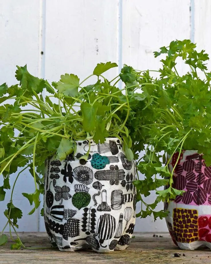 These are planters made out of recycled plastic bottles using the paper mache technique. It is then decoupaged with Marimekko napkins to give them a cool contemporary look. What's more, they're self-draining planters so don't worry about over-watering them!