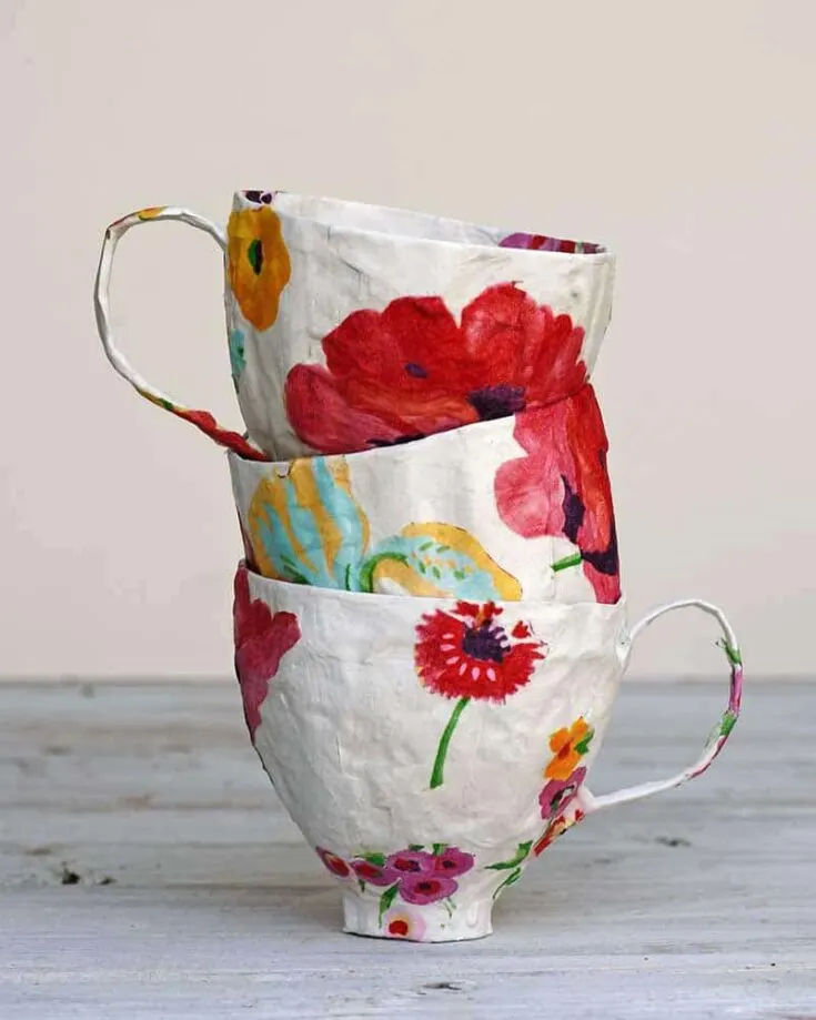 Discover how to make teacups out of paper mache by starting with a soda bottle and then decorating them by decoupaging napkins onto them!