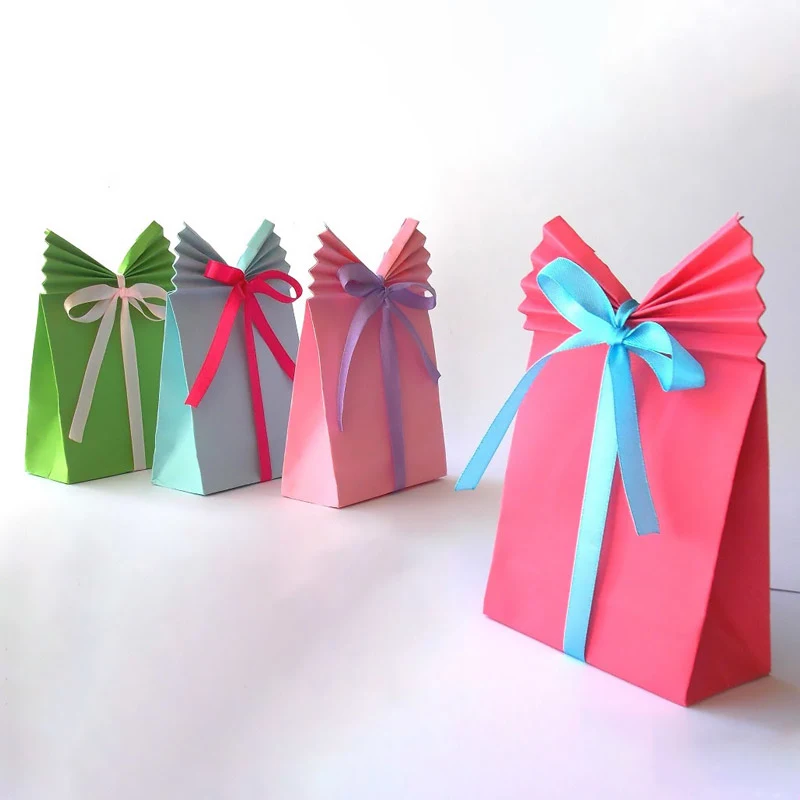 These DIY paper gift bags are incredibly stylish with their fan-like folded tops and colorful ribbons. They're such a fun and easy way to add a handmade touch to your gifts!