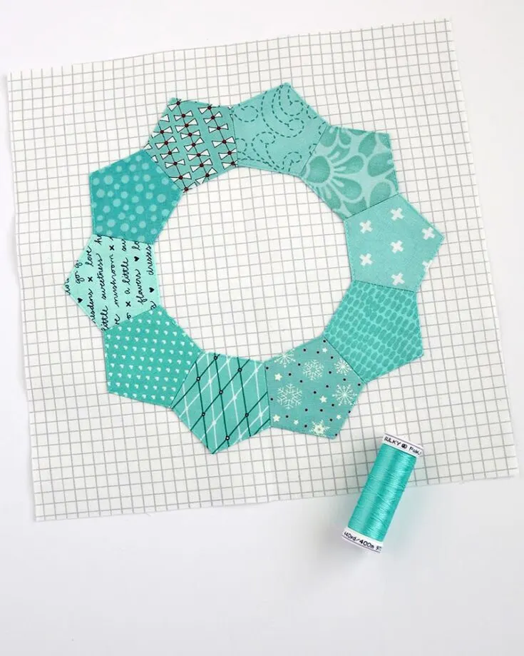 The appealing ring is made of ten pentagon pieces and is ideal for use as an applique on a sewing project. It is yet another beginner-friendly EPP project.