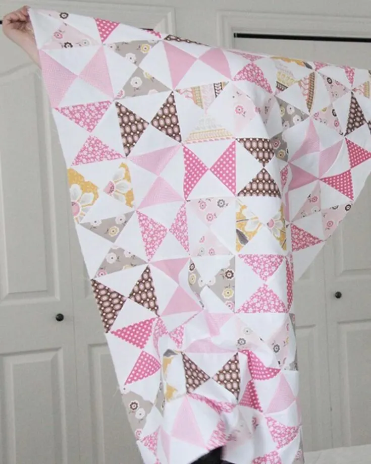 This classic pink baby quilt is perfect for any baby girl! This quilt pattern will create a cuddly masterpiece fit for the tiniest tots using the classic hourglass blocks. The finished size is 32&rdquo; x 41&rdquo;.