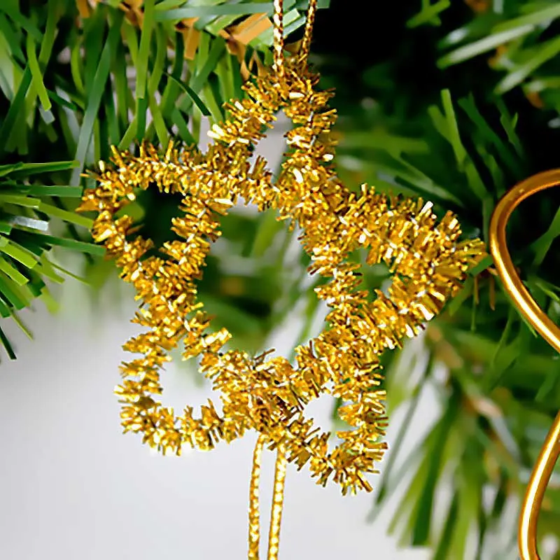 Add sparkle to your Christmas tree with these easy-to-craft glitter pipe cleaner stars. All you need is some glitter pipe cleaners along with nails to craft the pattern. These dazzling decorations are sure to shine bright all season long, making them a perfect addition to your collection of pipe cleaner Christmas crafts.