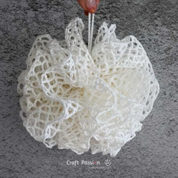 DIY your own shower scrubbie with this easy, beginner-friendly crochet loofah pattern. Great as a washcloth or bath pouf for everyday use or gifts!