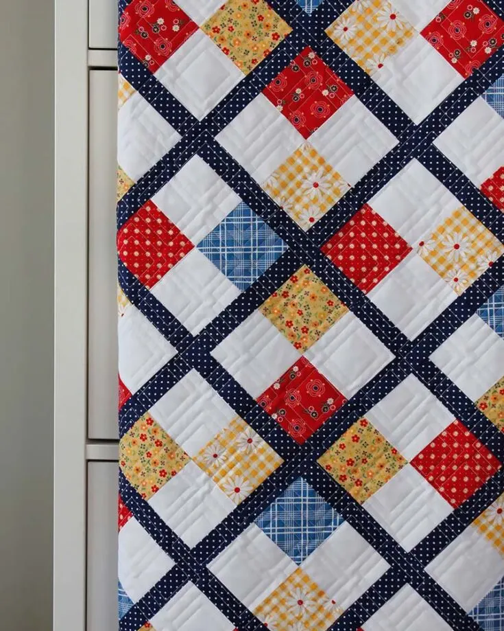 Challenge yourself to make this lovely quilt design with a Diagonal Plaid quilting effect for a fun texture. This 50" x 60" quilt uses five fat quarters and a little yardage for the sashing and backing, and this piece is an Argyle-inspired quilt! Sign up for the newsletter to access the downloadable PDF, and you'll be good to go!