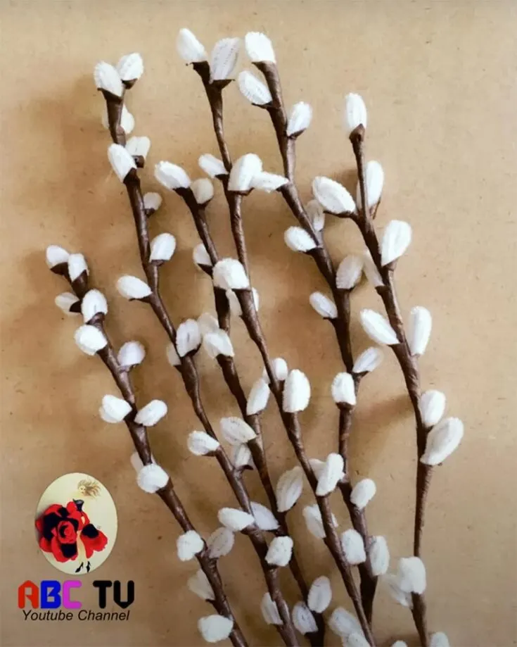 Instead of buying real pussy willow, you can DIY your own using pipe cleaners for a creative and festive touch. Decorate your pussy willow branches with red envelopes, mini lanterns, and gold ribbons for a festive flair, and enhance their charm with fairy lights or silk flowers for a touch of elegance and cheer.