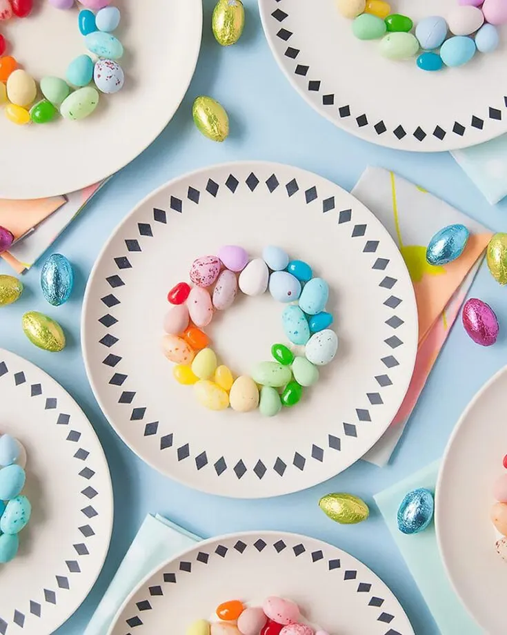 Grab some colorful jelly beans from the store and go crazy as you decorate your plates with these beautiful place setting ornamental decor. If you&rsquo;re running out of table space, you can always make these on paper plates as wall decor, too!
