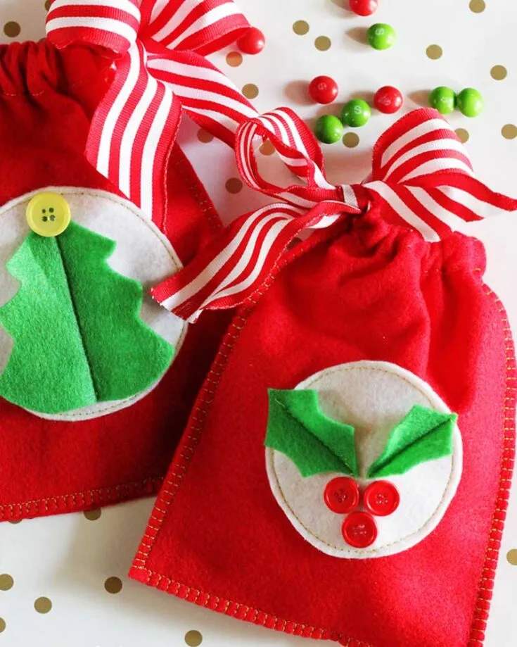Decorate these reusable felt gift bags with classic Christmas felt shapes like mistletoe and trees, plus bright buttons. These easy drawstring bags can be enjoyed year after year!