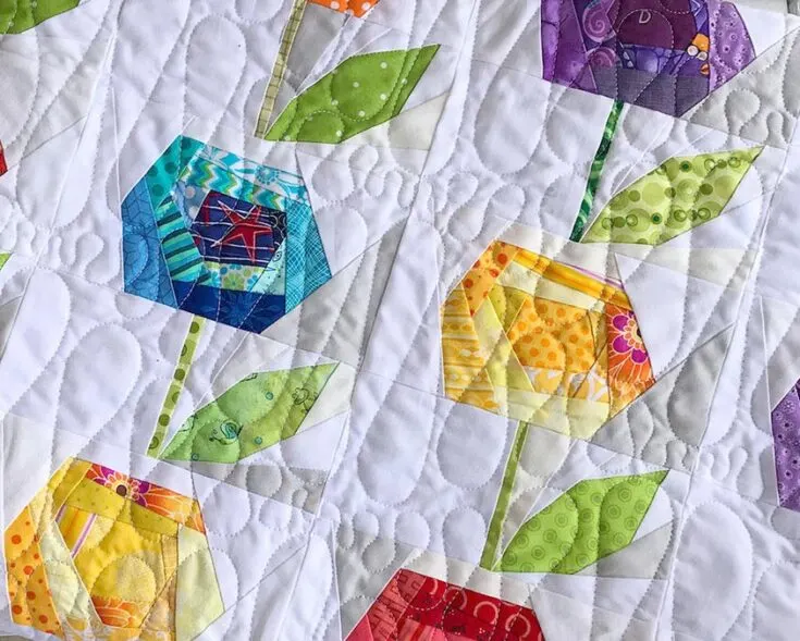 Here's another scrap buster for you. This scrap flower quilt block would fit well in any of your floral springtime projects with its childlike vibrance! With the many petals overlapping each other on the bud, you wouldn't need to worry much about precision.