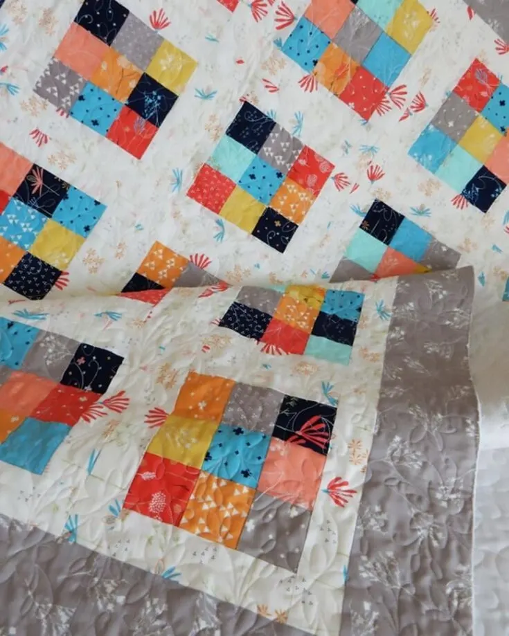 Create a visually pleasing and timeless quilt by following this Scrappy 9 Patch quilt tutorial! It&rsquo;s a straightforward design, yet it looks so well put together, and the pattern lets your creativity run free with the fun play of colors! The size of a smaller quilt would measure 52 &frac12;&rdquo; x 61 &frac12;&rdquo;, and a larger piece would be an estimate of 61 &frac12;&rdquo; x 70 &frac12;&rdquo;.