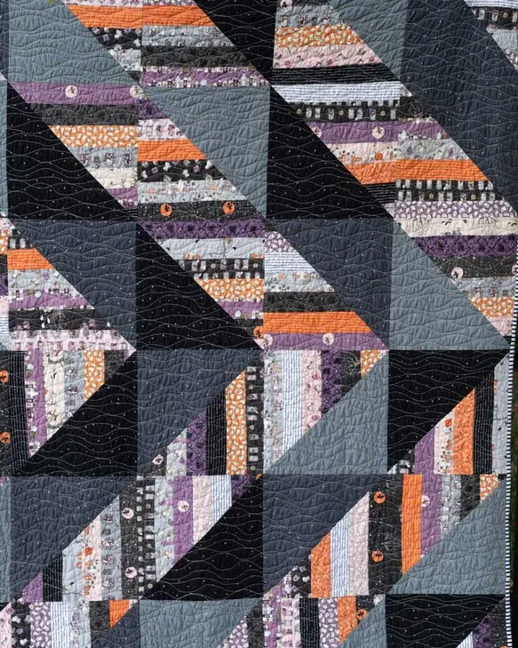 This Scrappy Triangles jelly roll quilt pattern will add some pizzazz to your quilting repertoire. The geometrical shapes in the design create so much personality in the quilt, and the fabric's textures make for a great Halloween and fall-themed blanket, too. All you would need is a sewing machine and to quilt wavy lines that overlap intentionally. Size: 65&rdquo; x 78&rdquo;