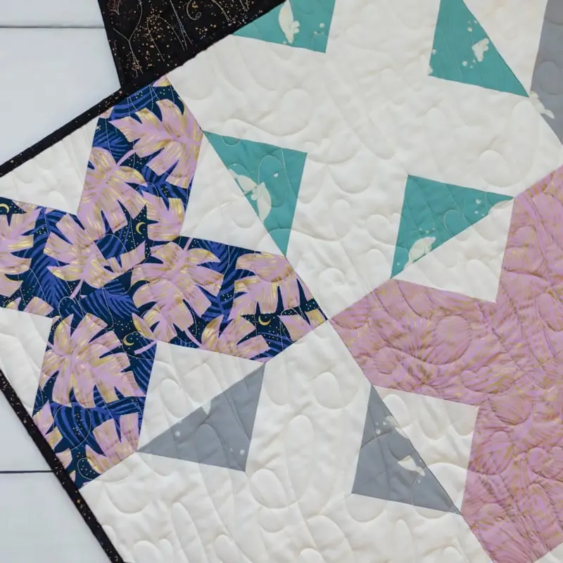 Learn to make this classic signature cross quilt pattern that is quickly sewn and is a beginner-level project! This 60" x 60" throw quilt uses repetitive signature blocks in a bold, more graphic layout with alternating prints and white 'X's. What better way to spend the weekend than to quilt this lovely piece?