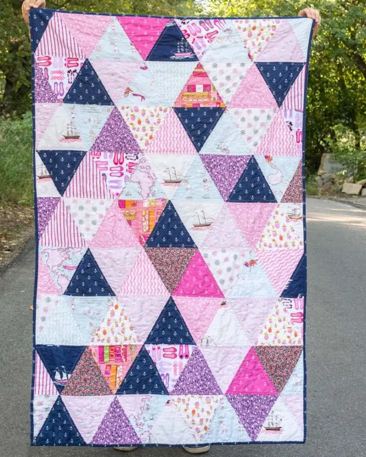 Welcome to a world where triangles reign supreme! On top of that, the pop of geometric shapes is so unique. Although the design for this baby quilt is slightly bigger, 46&rdquo; x 72&rdquo;, it is such a comfy and cozy quilt for your baby to cuddle in. Try it out now.
