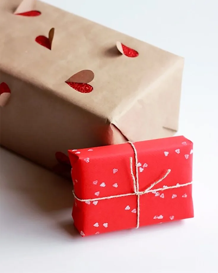 A way to glam up your gift-wrapping game for Valentine's would be this old brown rustic wrapping paper with pop-up hearts cut using an X-ACTO knife.